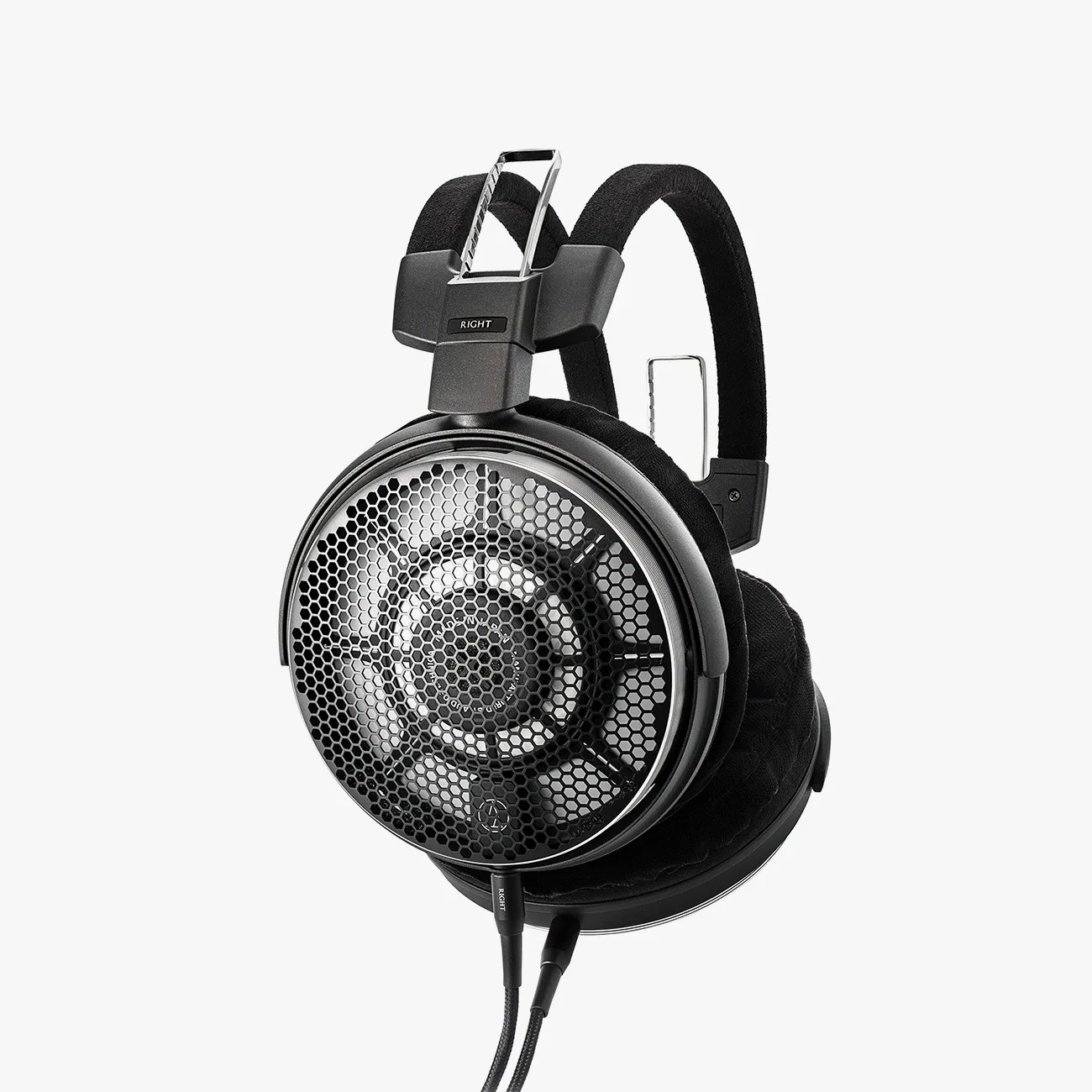 Black open-back over-ear headphones with honeycomb metal grille and padded headband.