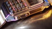 Close-up of a metallic digital wristwatch with multiple buttons and a reflective surface.