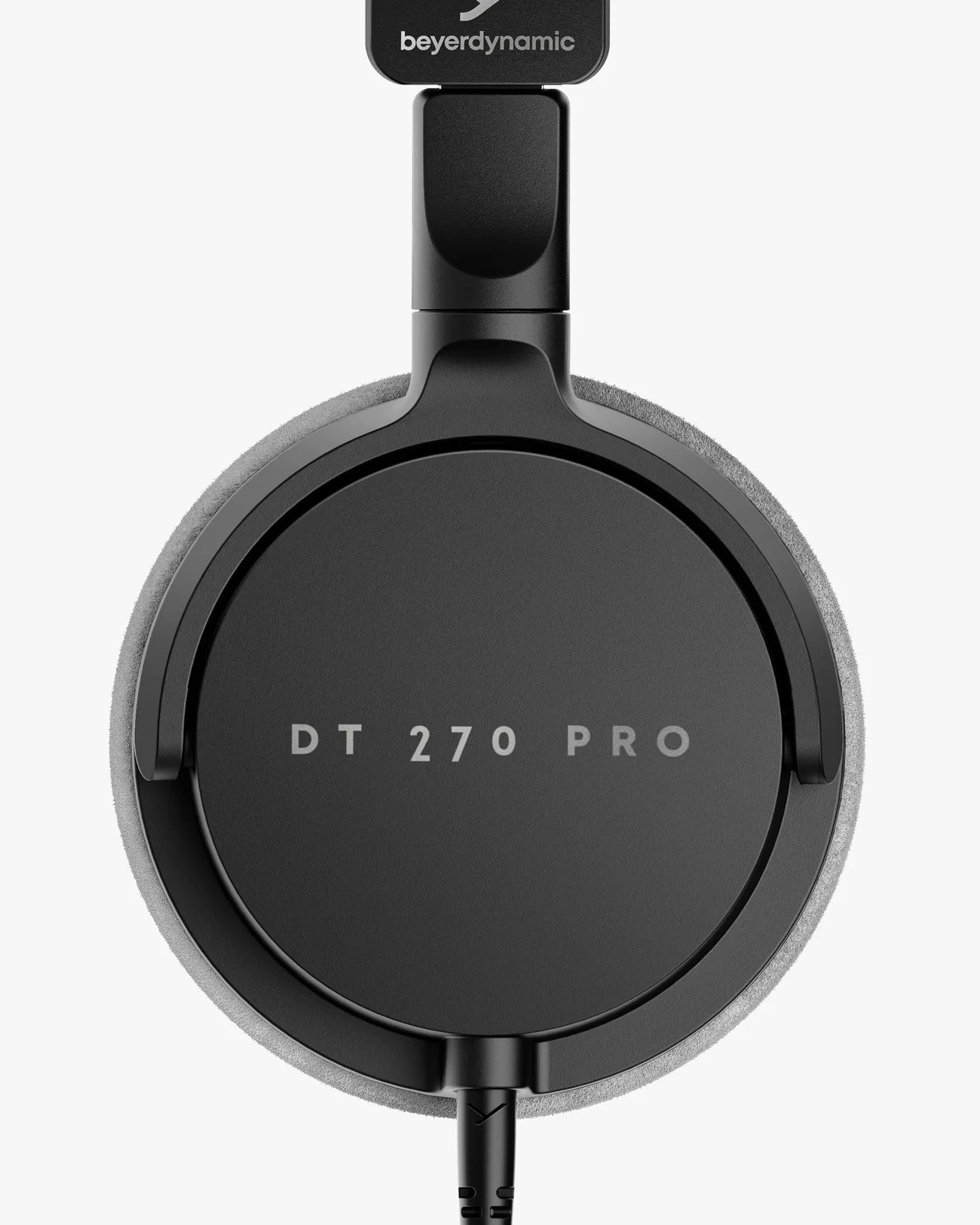 Close-up of black Beyerdynamic DT 270 Pro headphone ear cup with gray foam padding and attached cable.
