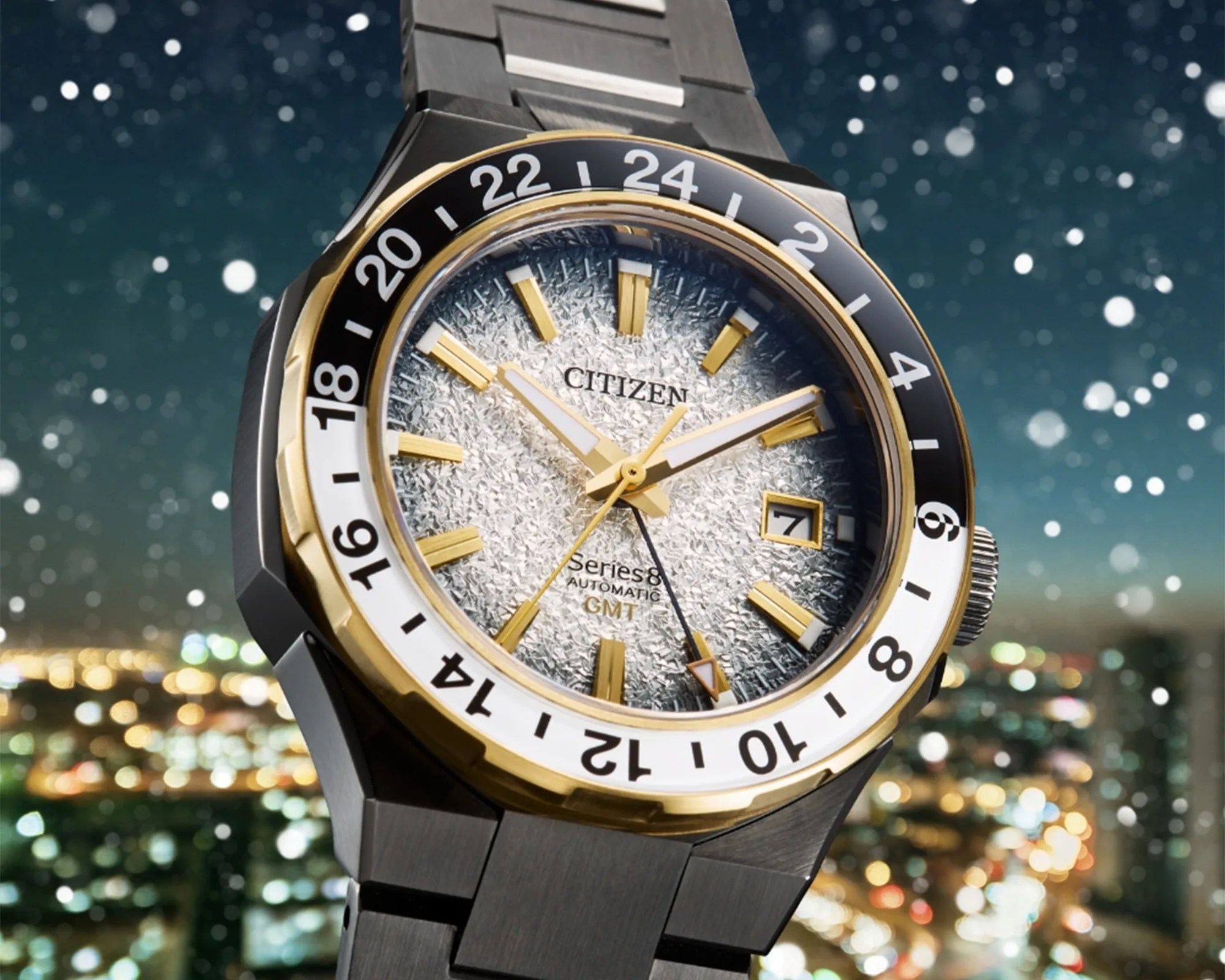 Citizen Series 8 GMT watch with textured silver dial, gold accents, black and white 24-hour bezel, and metal bracelet.