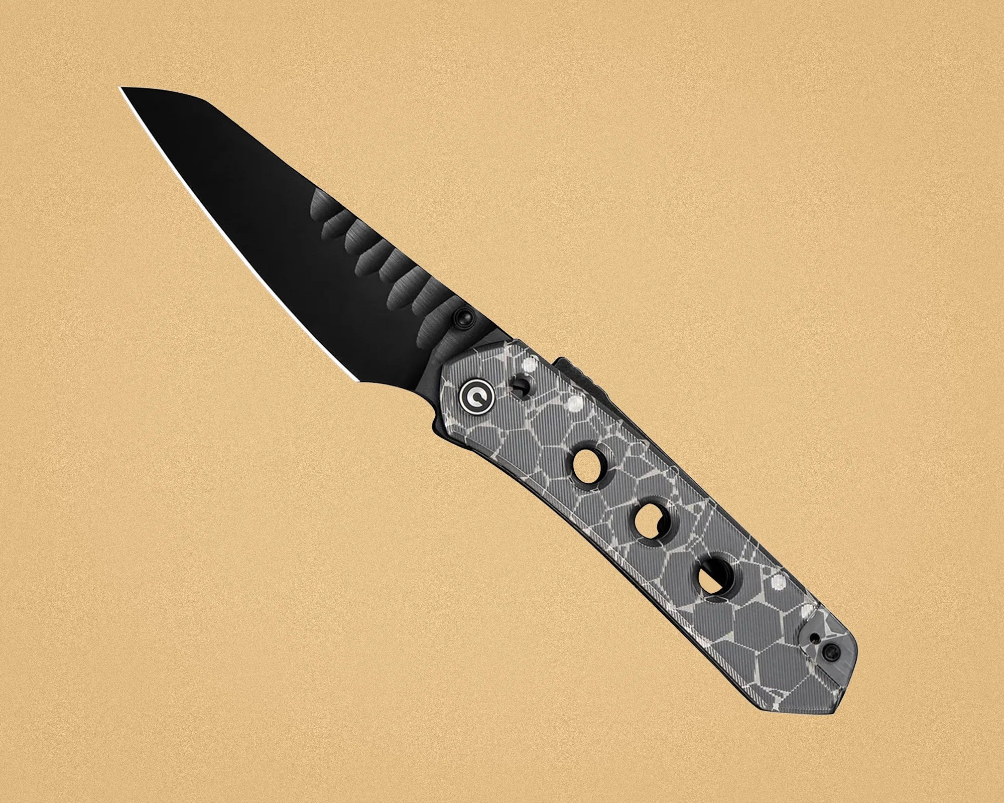 Folding knife with black blade and gray hexagonal patterned handle with three circular holes.