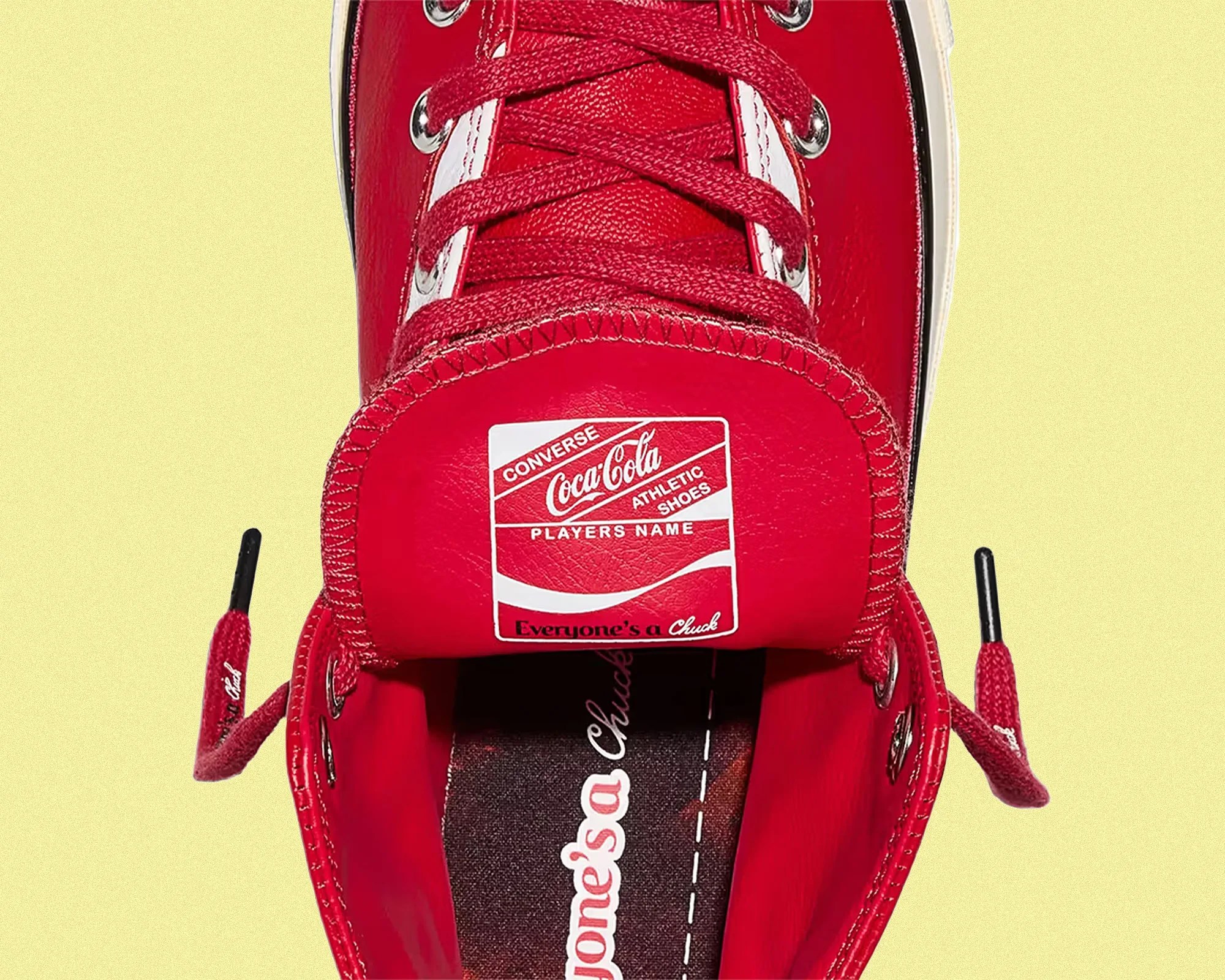 Top view of a red Converse Coca-Cola collaboration sneaker with red laces and white label on the tongue.