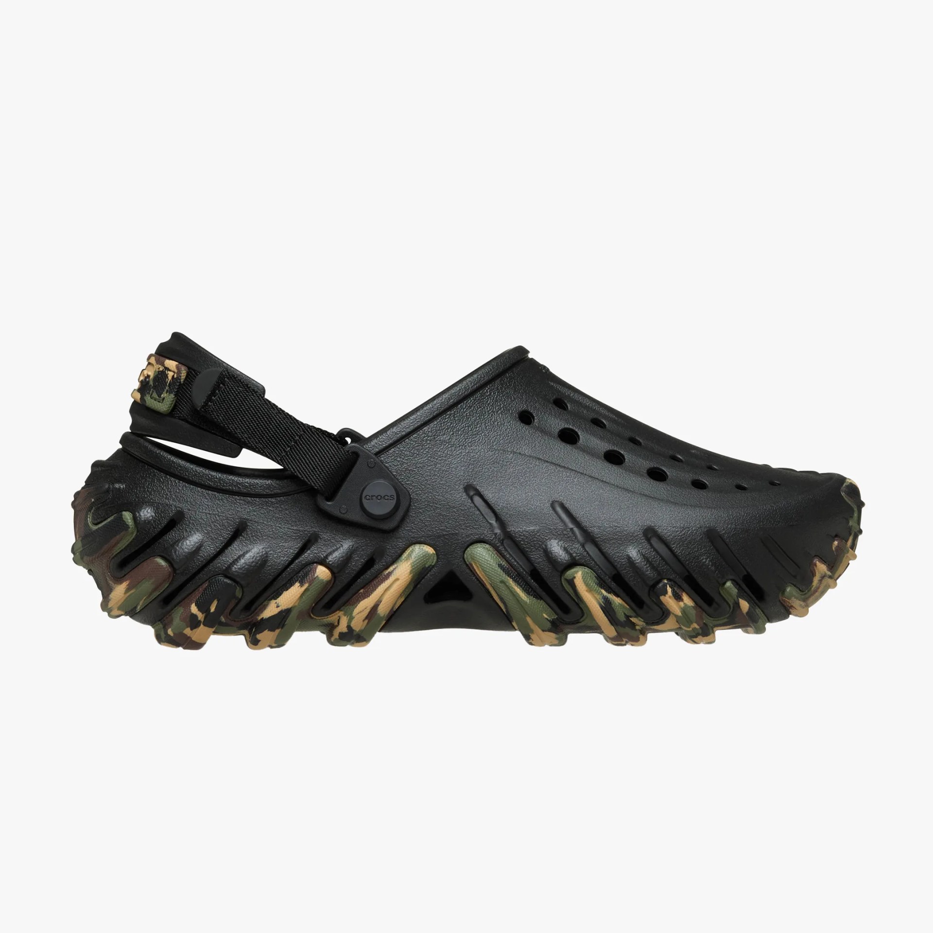 Black Crocs clog with camo-patterned sole and adjustable black strap.