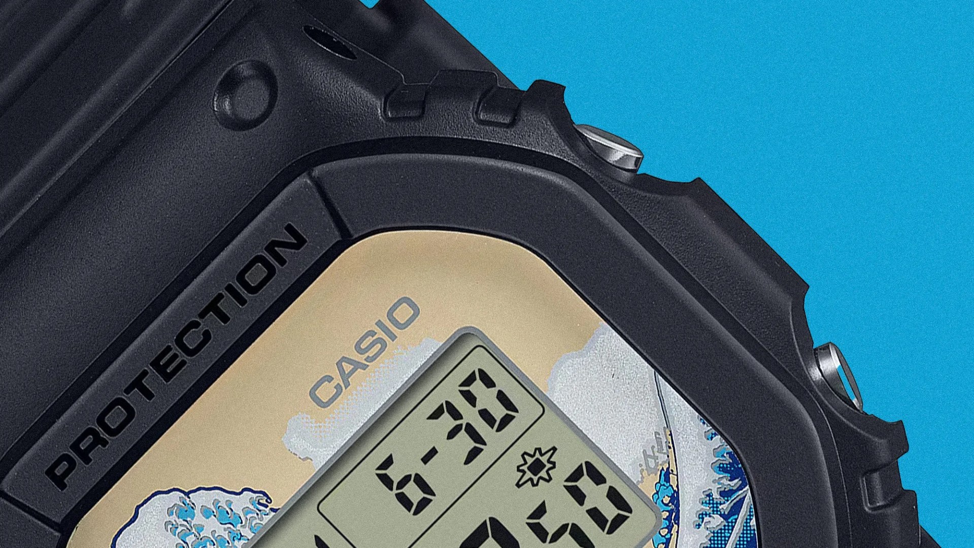 Close-up of a black Casio digital watch with "PROTECTION" text and a decorative wave pattern on the face.