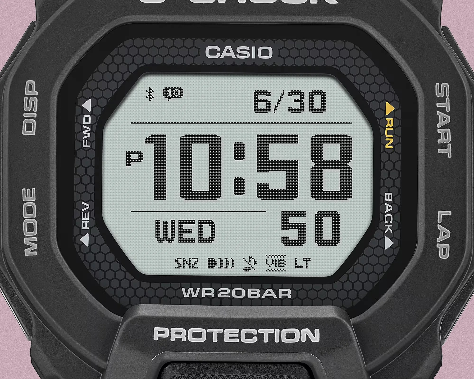 Close-up of a black Casio G-Shock digital watch face showing time 10:58, date 6/30, and day Wednesday.