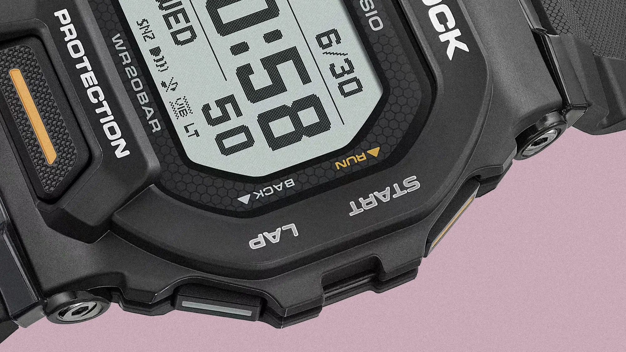 Close-up of a black Casio G-Shock digital watch face showing time, date, and buttons labeled Protection, Start, and Lap.