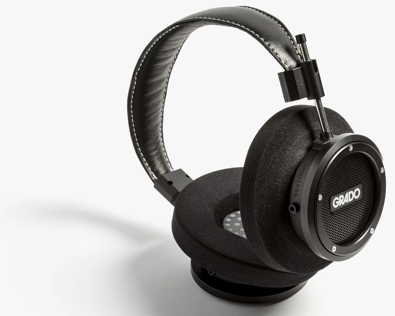 Black Grado Labs over-ear headphones with foam ear pads and padded leather headband on a white background.