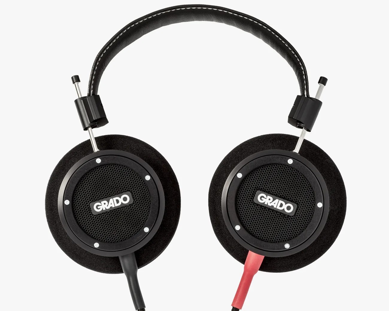 Black Grado over-ear headphones with foam ear pads and a black and red cable.