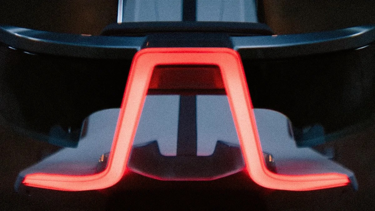 Rear view of a car's illuminated red LED taillight with a distinctive angular design.