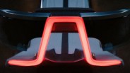 Rear view of a car's illuminated red LED taillight with a distinctive angular design.