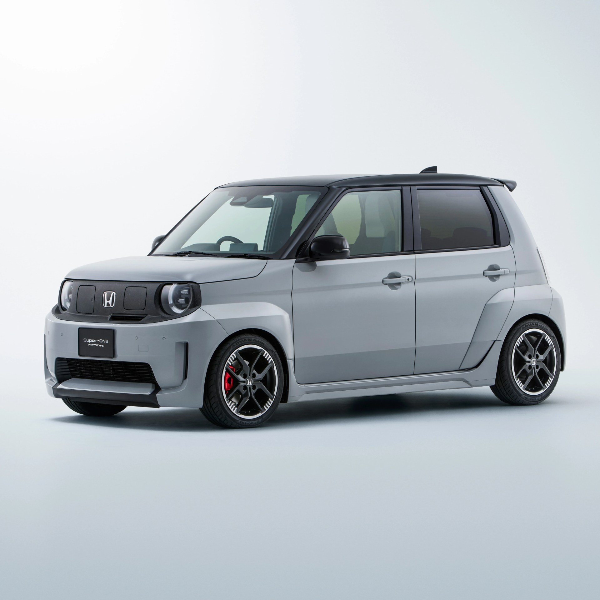 Compact silver Honda Super One prototype car with black roof and sporty black alloy wheels on a white background.