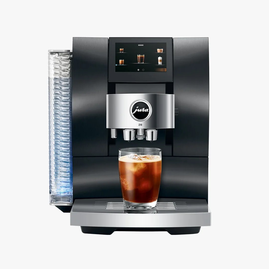 Black and silver Jura Z10 coffee machine with touchscreen and glass of iced coffee on drip tray.