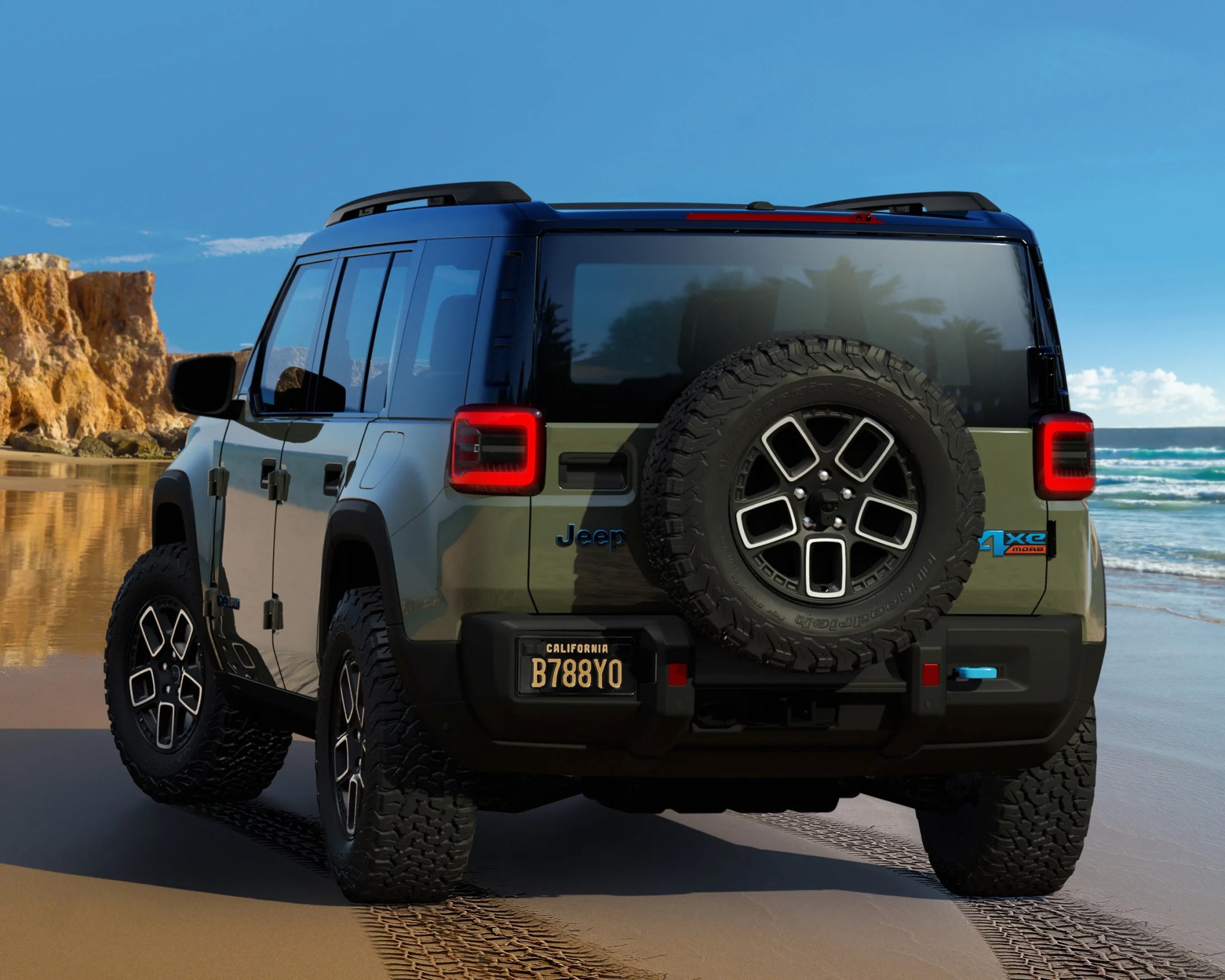 Green Jeep 4xe Moab SUV with spare tire on rear, parked on a sandy beach near cliffs and ocean.