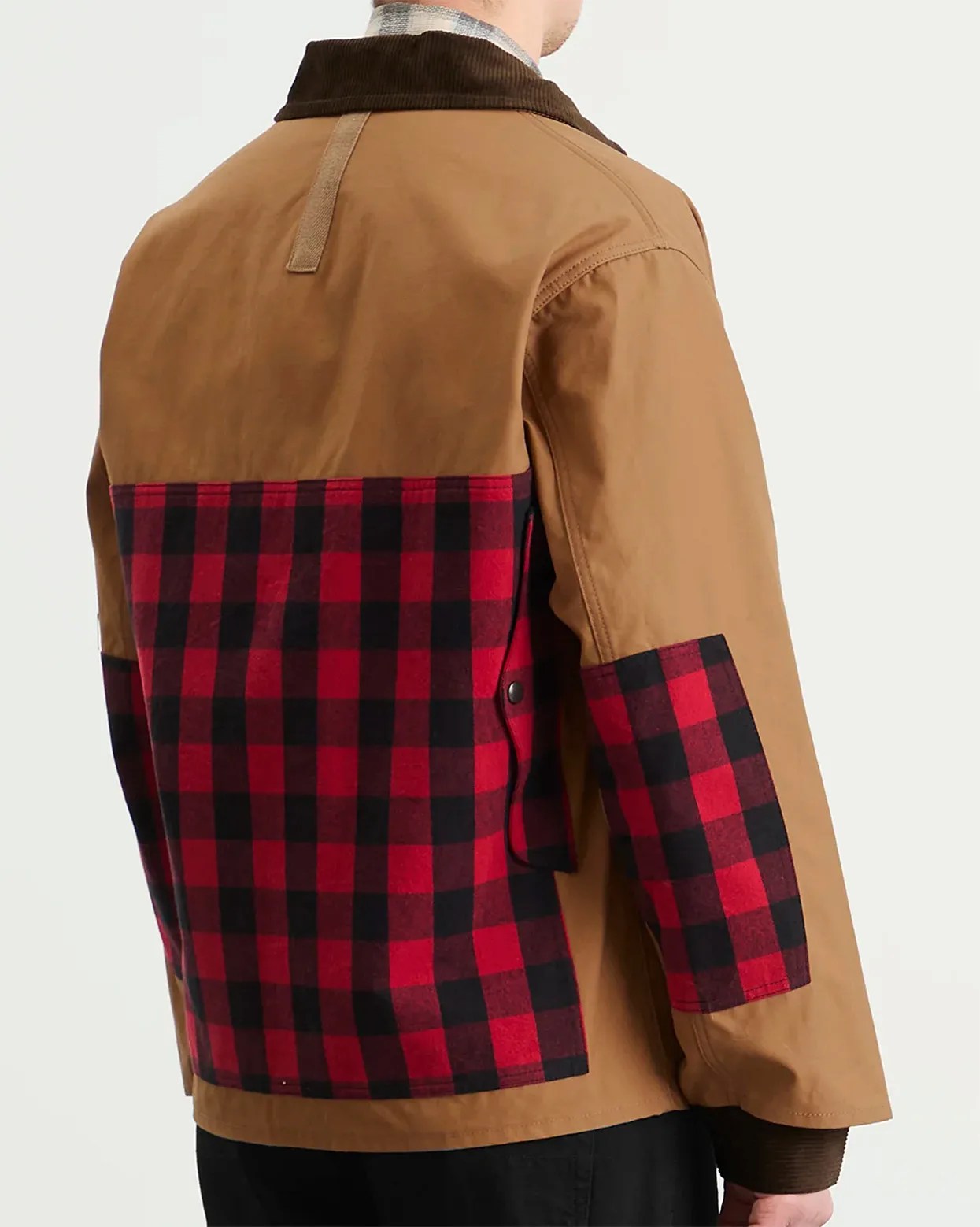 Brown jacket with red and black checkered fabric panel on the back and sleeves, worn by a person.
