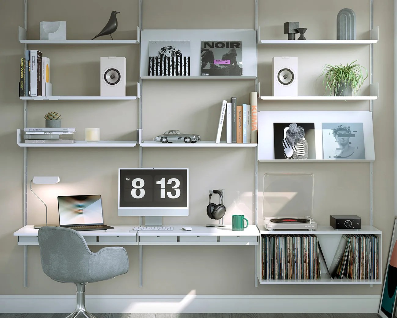 Modern home office setup with white wall-mounted shelves holding books, speakers, vinyl records, a turntable, and a computer on a white desk with a gray swivel chair.