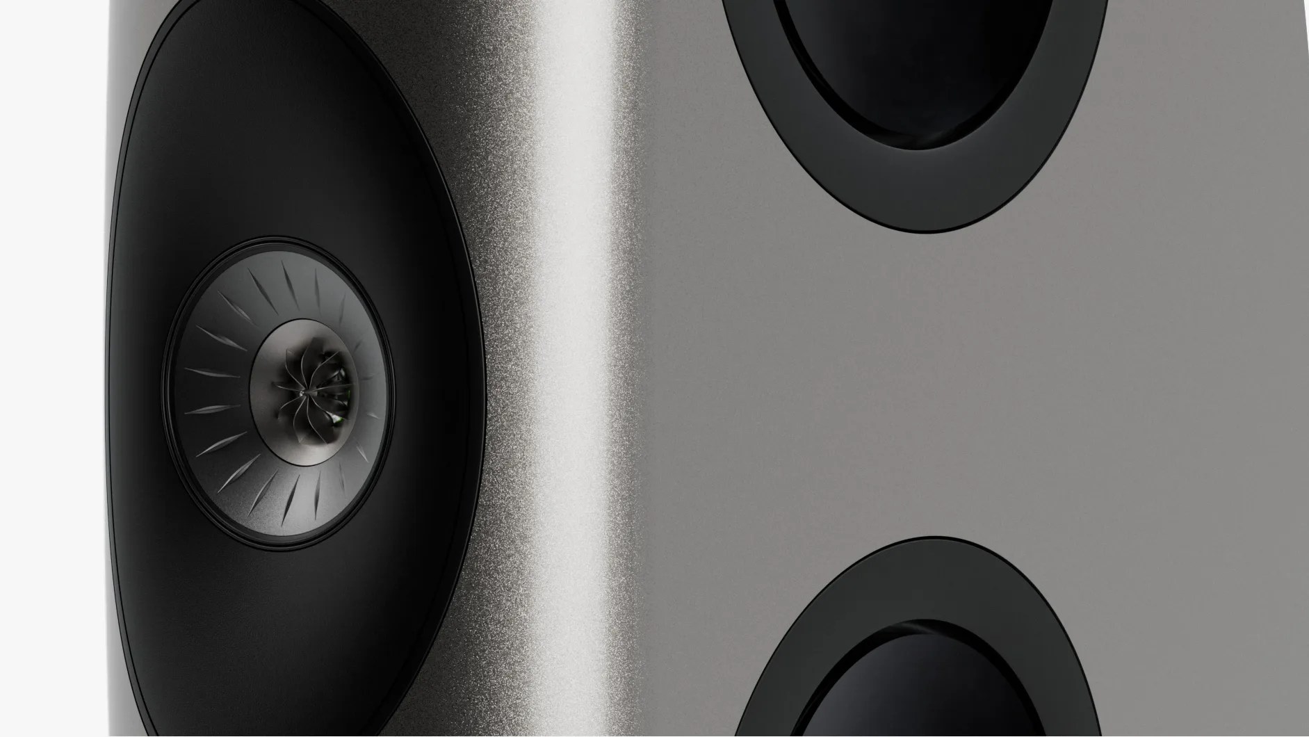 Close-up of a metallic gray speaker with a black cone and a central turbine-like design.