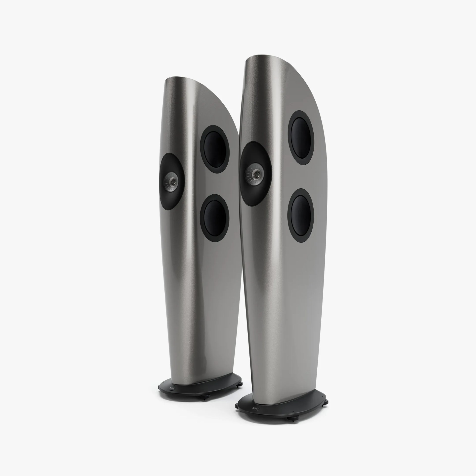 Pair of tall, curved silver floor-standing speakers with black drivers and rounded black bases.