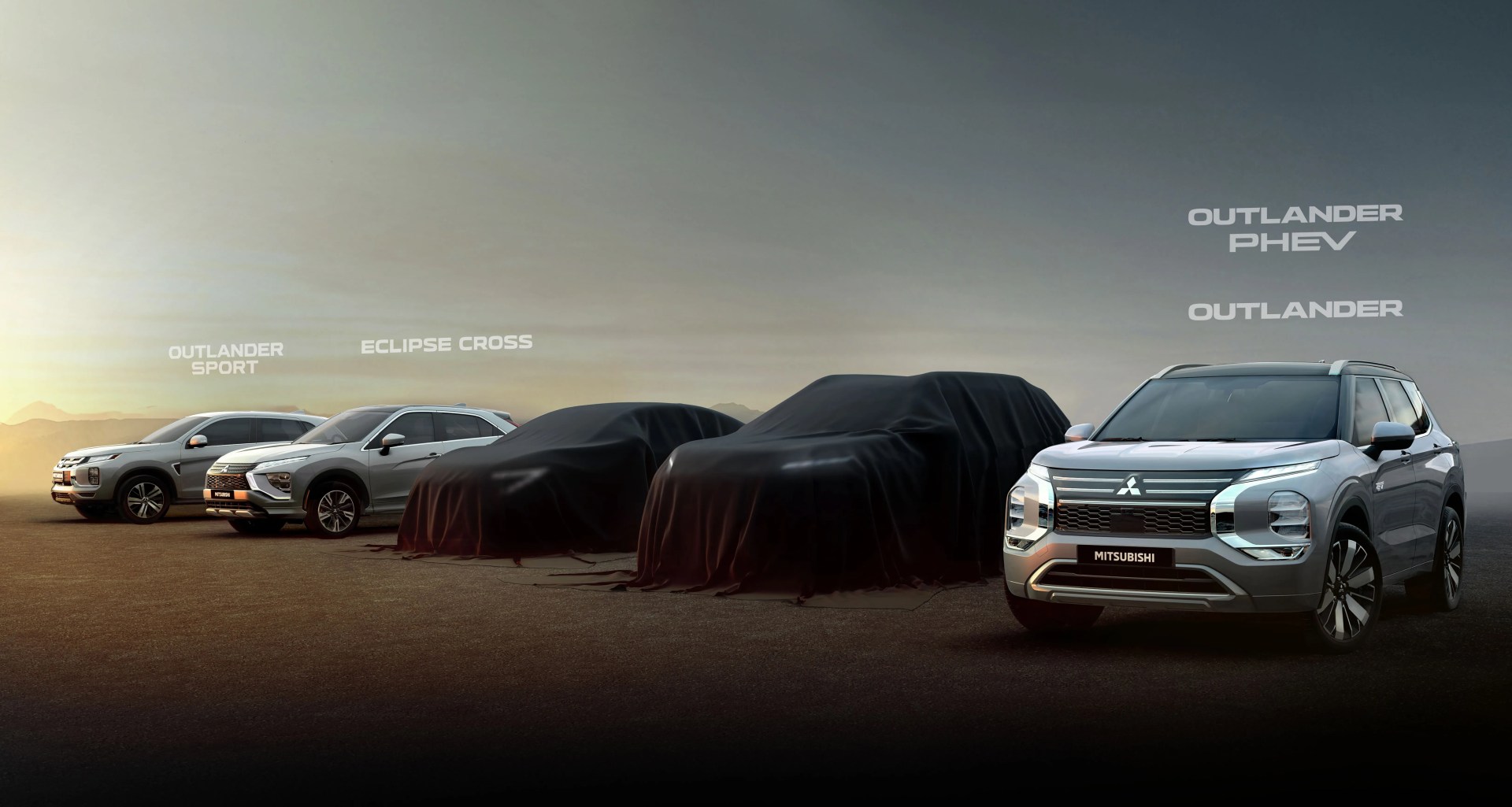 Five Mitsubishi SUVs lined up on a flat surface at sunset, with three covered in black cloth and two uncovered labeled Outlander Sport, Eclipse Cross, Outlander PHEV, and Outlander.