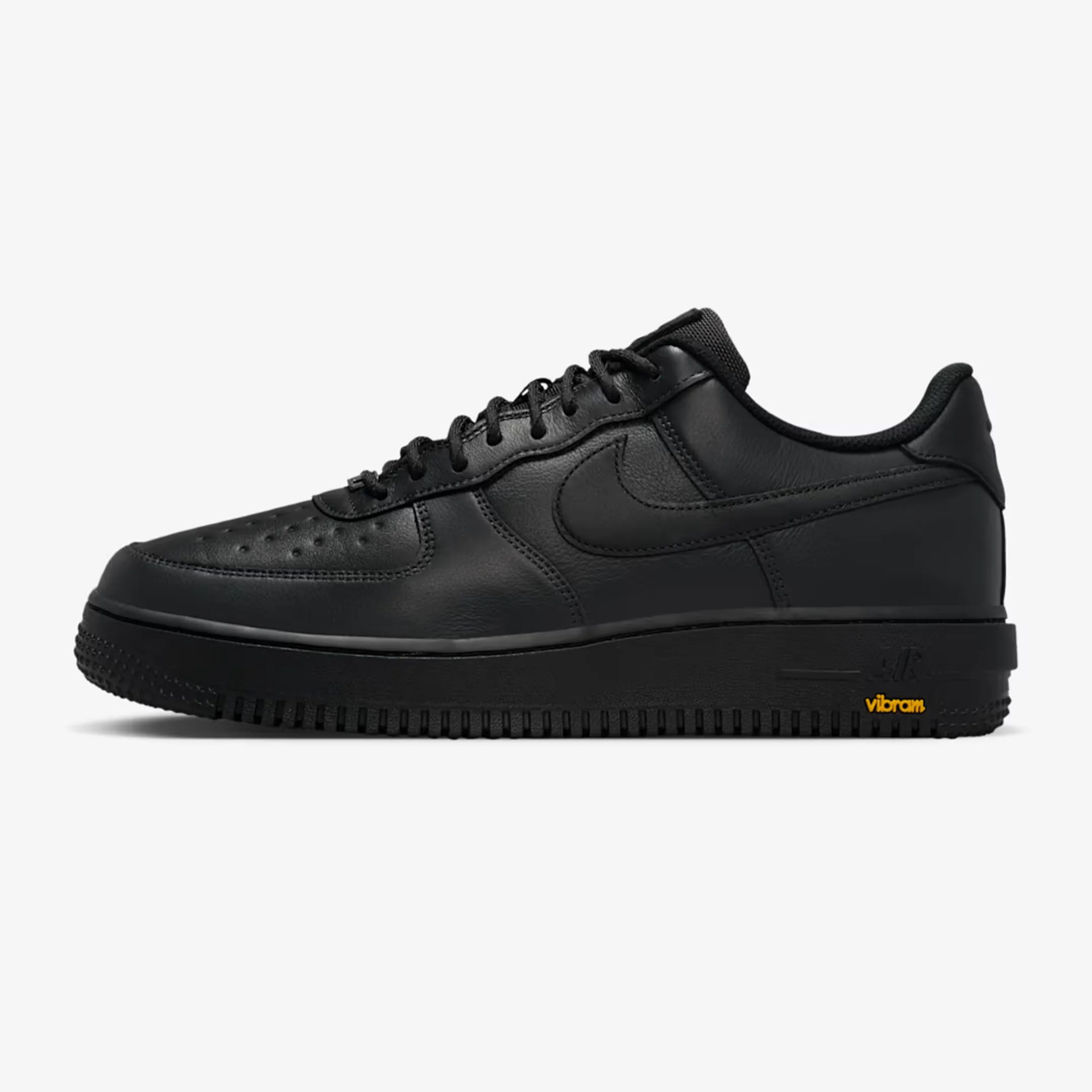 All-black low-top Nike Air Force 1 sneaker with leather upper and Vibram sole.