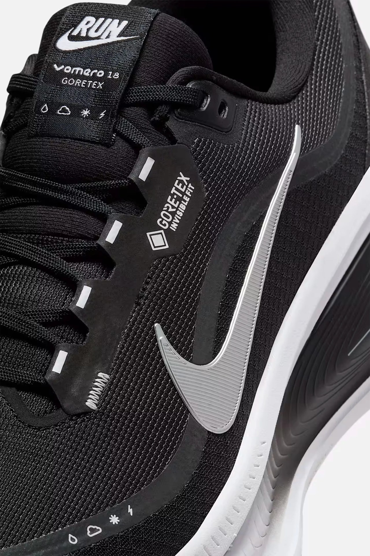 Close-up of a black Nike running shoe with white swoosh, Gore-Tex Invisible Fit label, and white sole.
