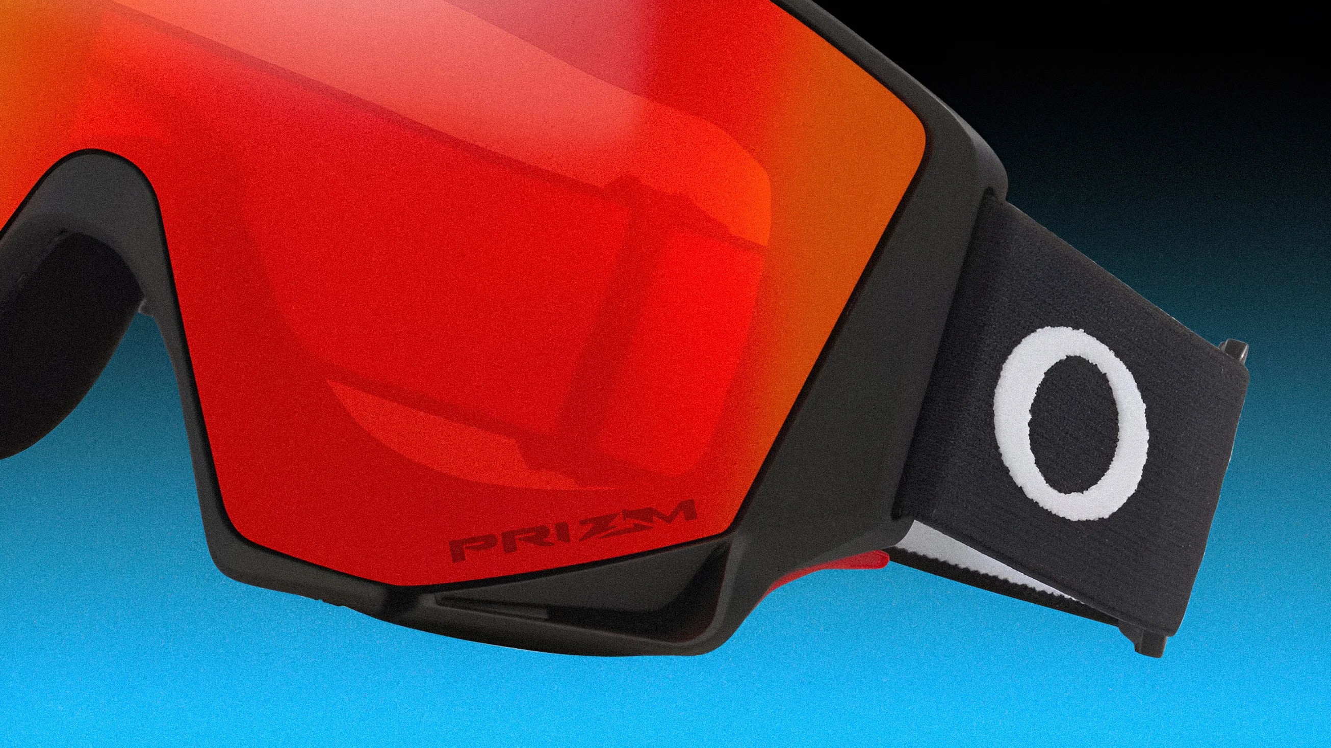 Black-framed Oakley goggles with red Prizm lens and black strap featuring a white Oakley logo.