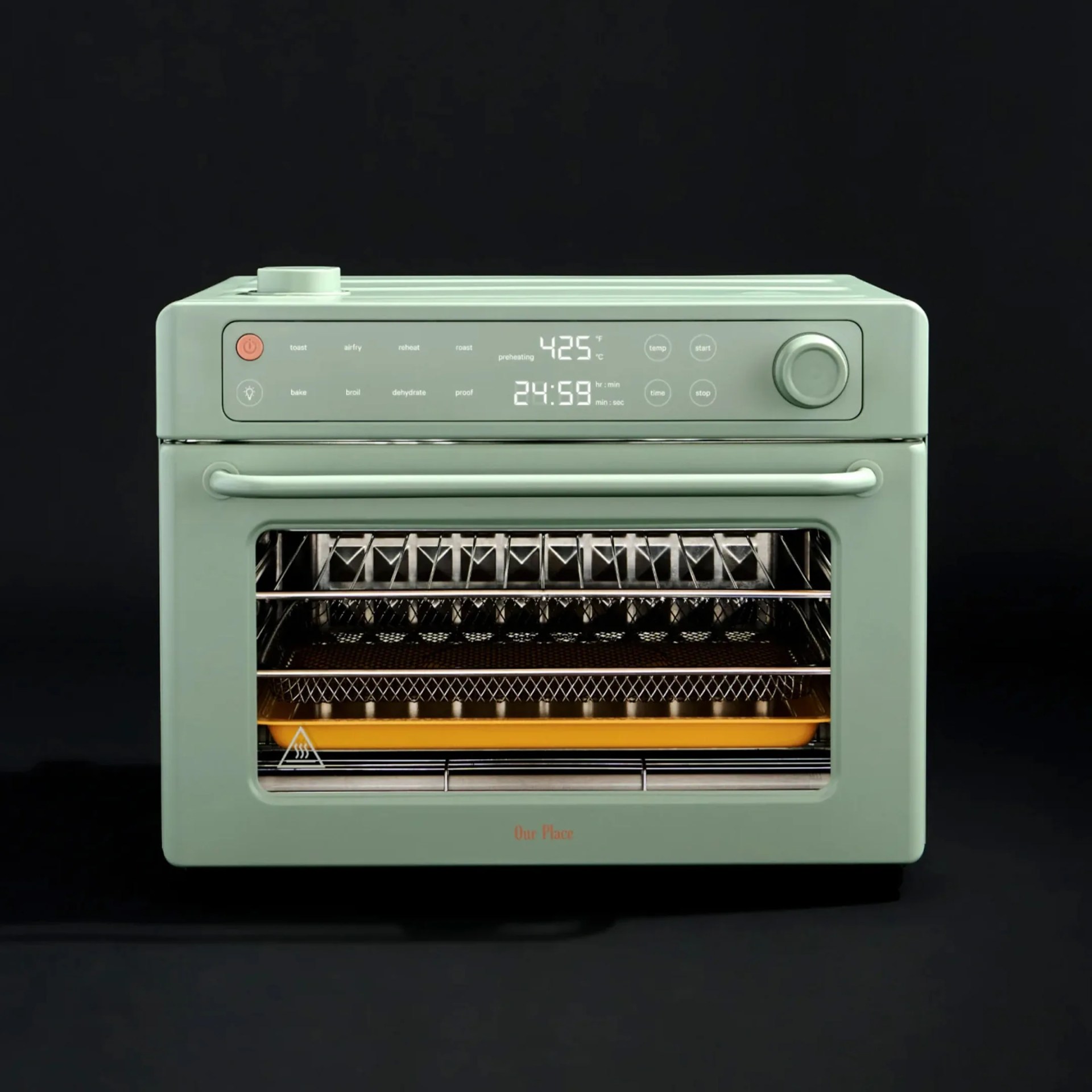 Mint green countertop oven with digital display and control knob on top, showing temperature and timer.