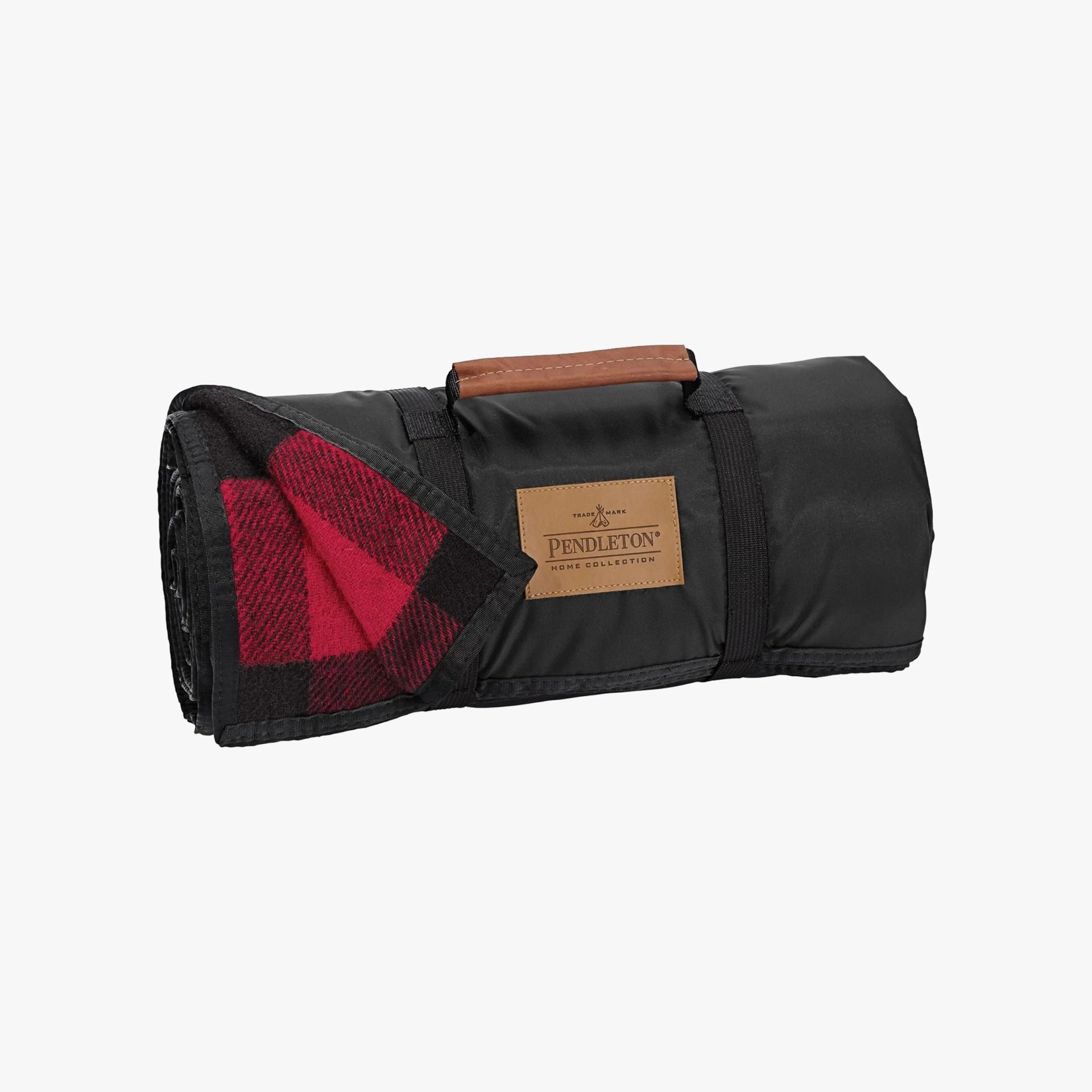 Rolled black Pendleton blanket with red and black plaid interior and brown leather handle.