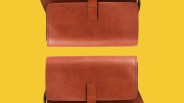 Two brown leather crossbody bags with flap closures on a yellow background.