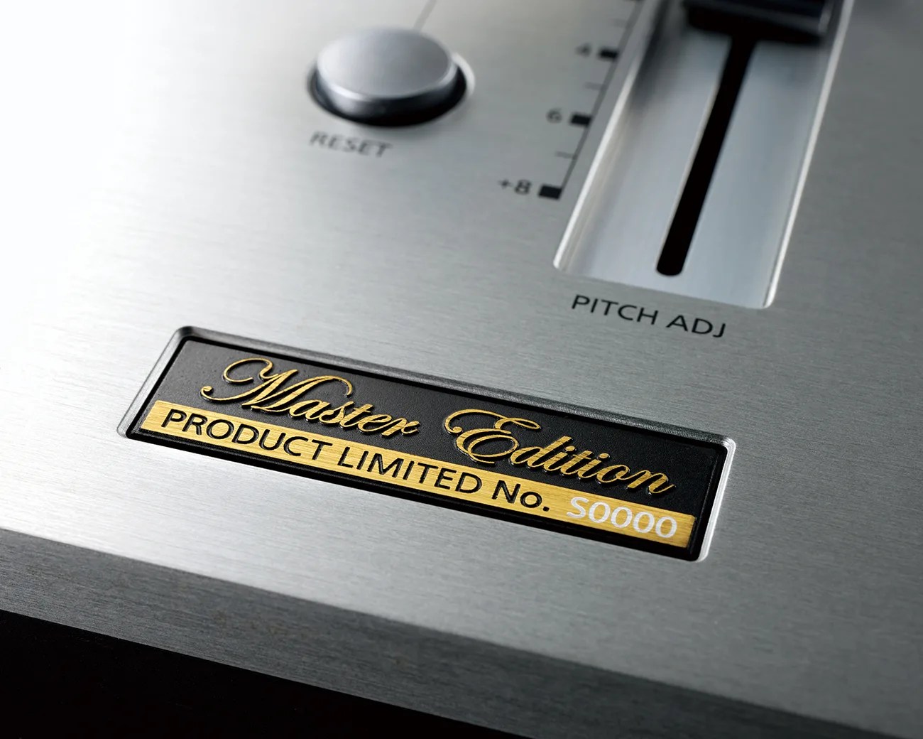 Close-up of a silver brushed metal panel with a black and gold "Master Edition PRODUCT LIMITED No. S0000" label, a reset button, and a pitch adjustment slider.