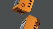 Two orange retro-style toasters with chrome accents and black levers on a gray background.