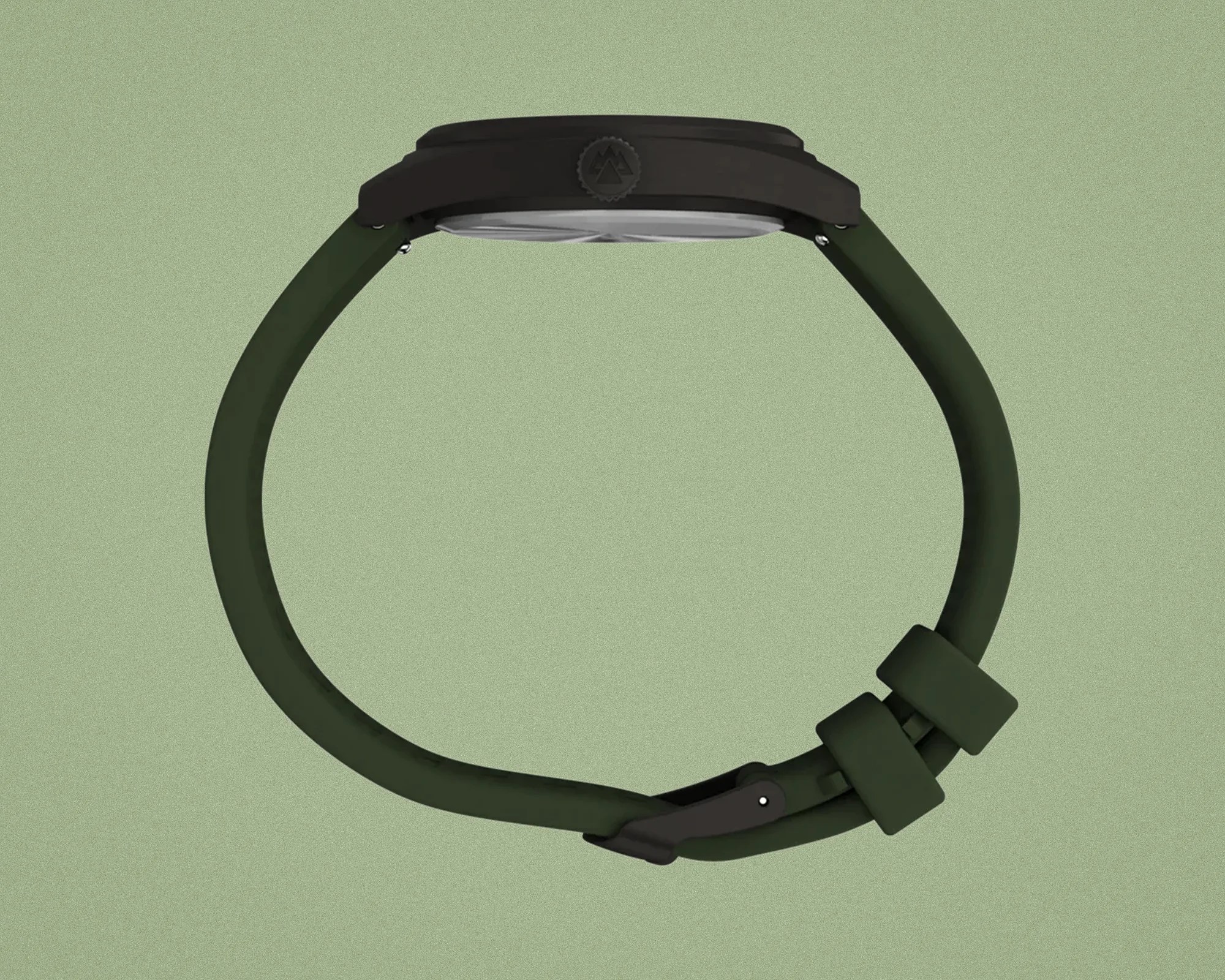 Side view of a black watch case with a dark green silicone strap and black buckle on a green background.