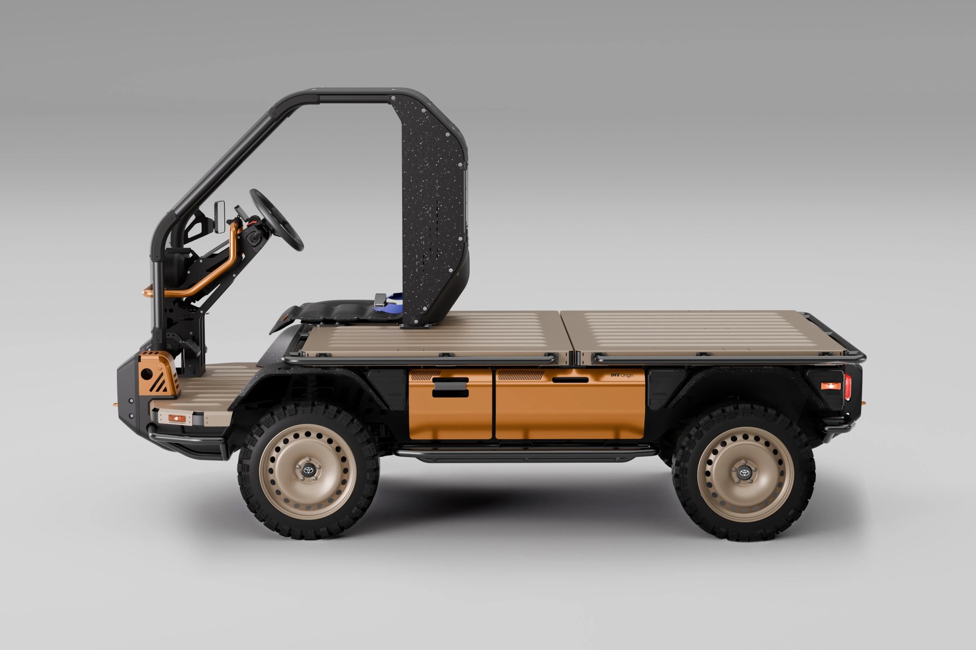 Compact utility vehicle with tan flatbed, black frame, and single black seat with steering wheel.