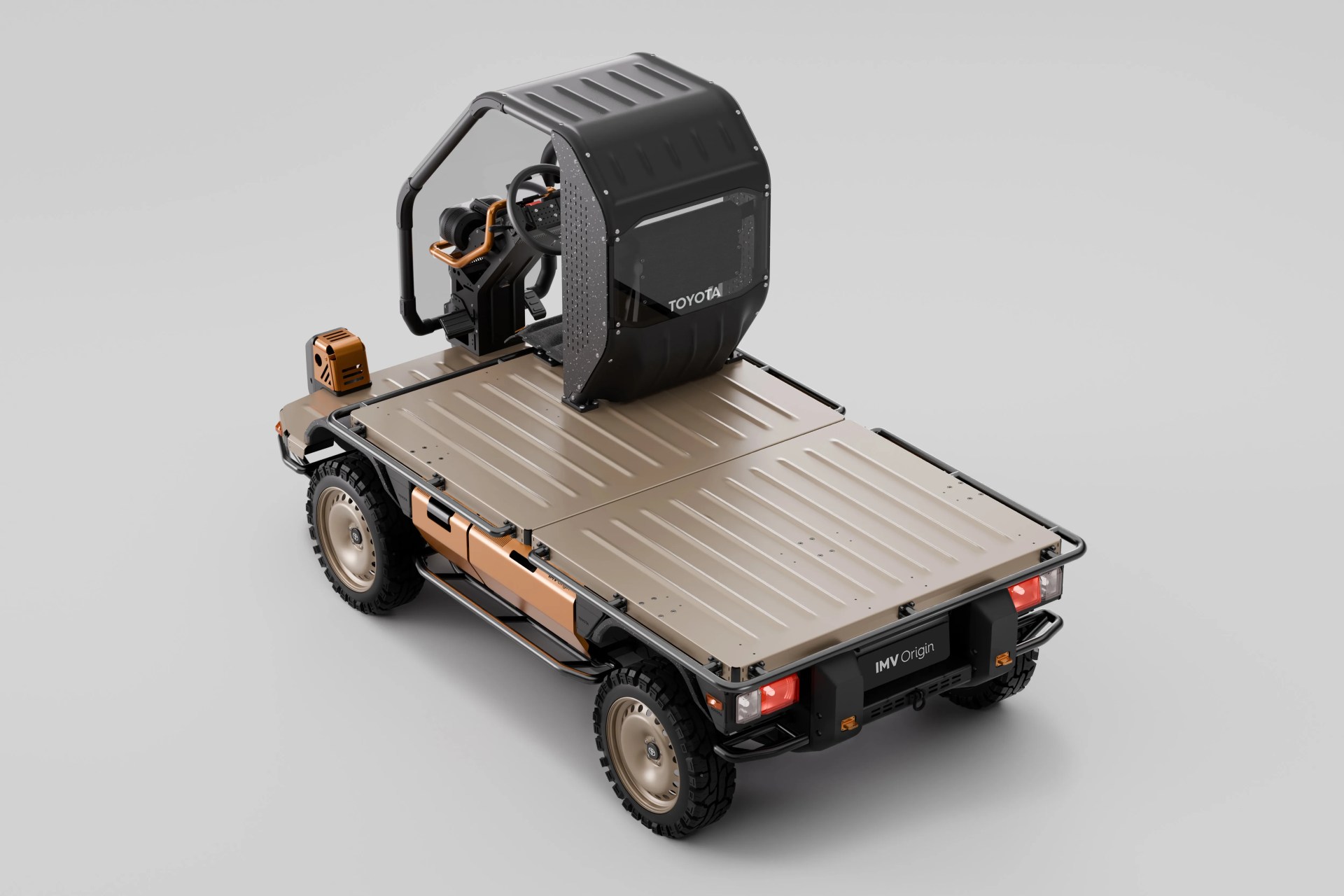 Compact flatbed utility vehicle with beige cargo area, black protective frame, and single black seat with canopy labeled "Toyota.