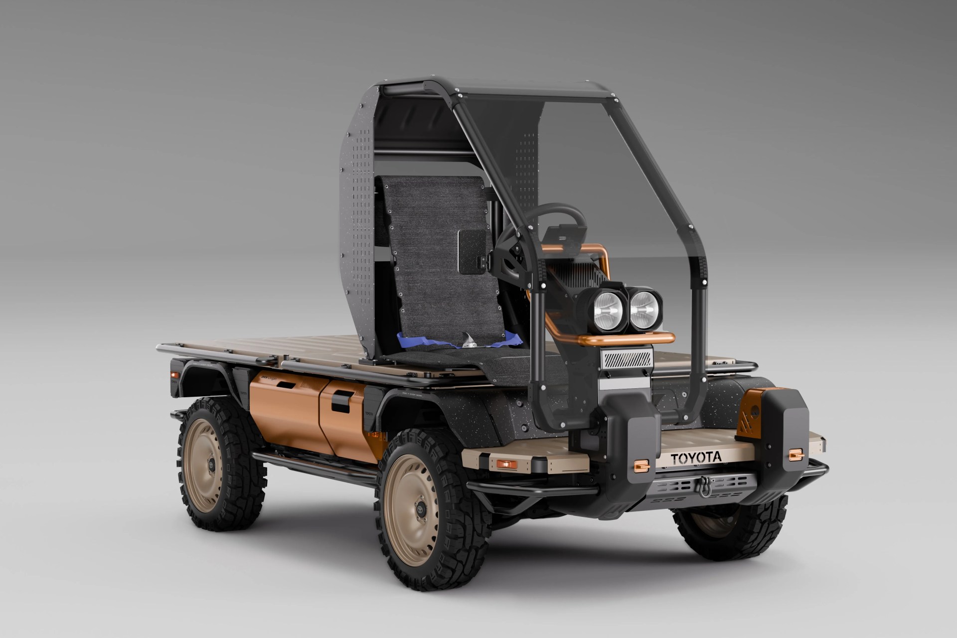 Compact flatbed utility vehicle with rugged tires, single seat, and protective frame, branded Toyota.