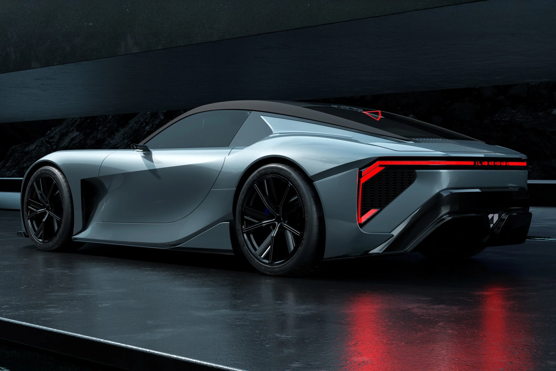 Sleek silver sports car with black roof and angular red LED taillights on a reflective dark floor.
