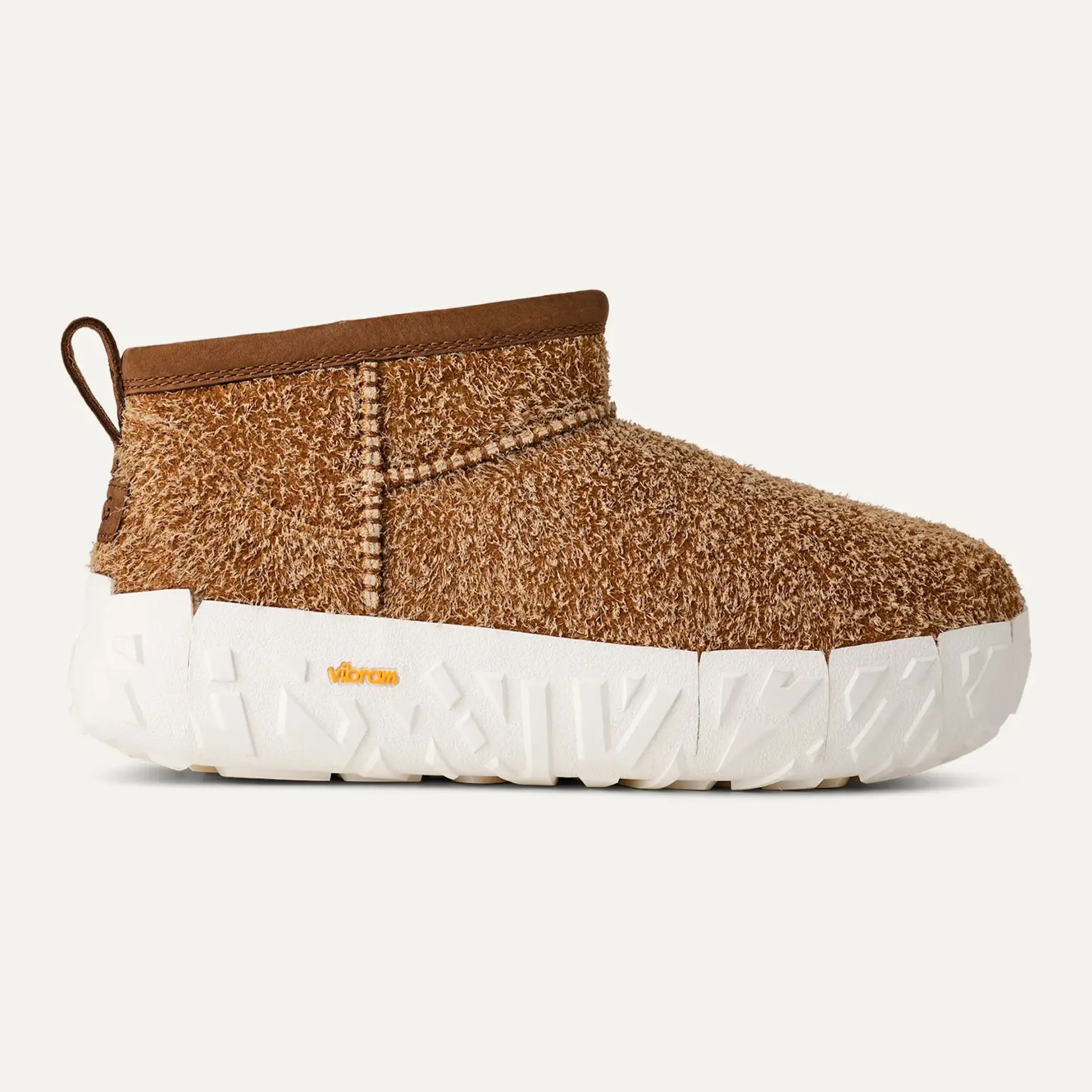 Brown textured slip-on shoe with thick white Vibram sole and pull tab at heel.