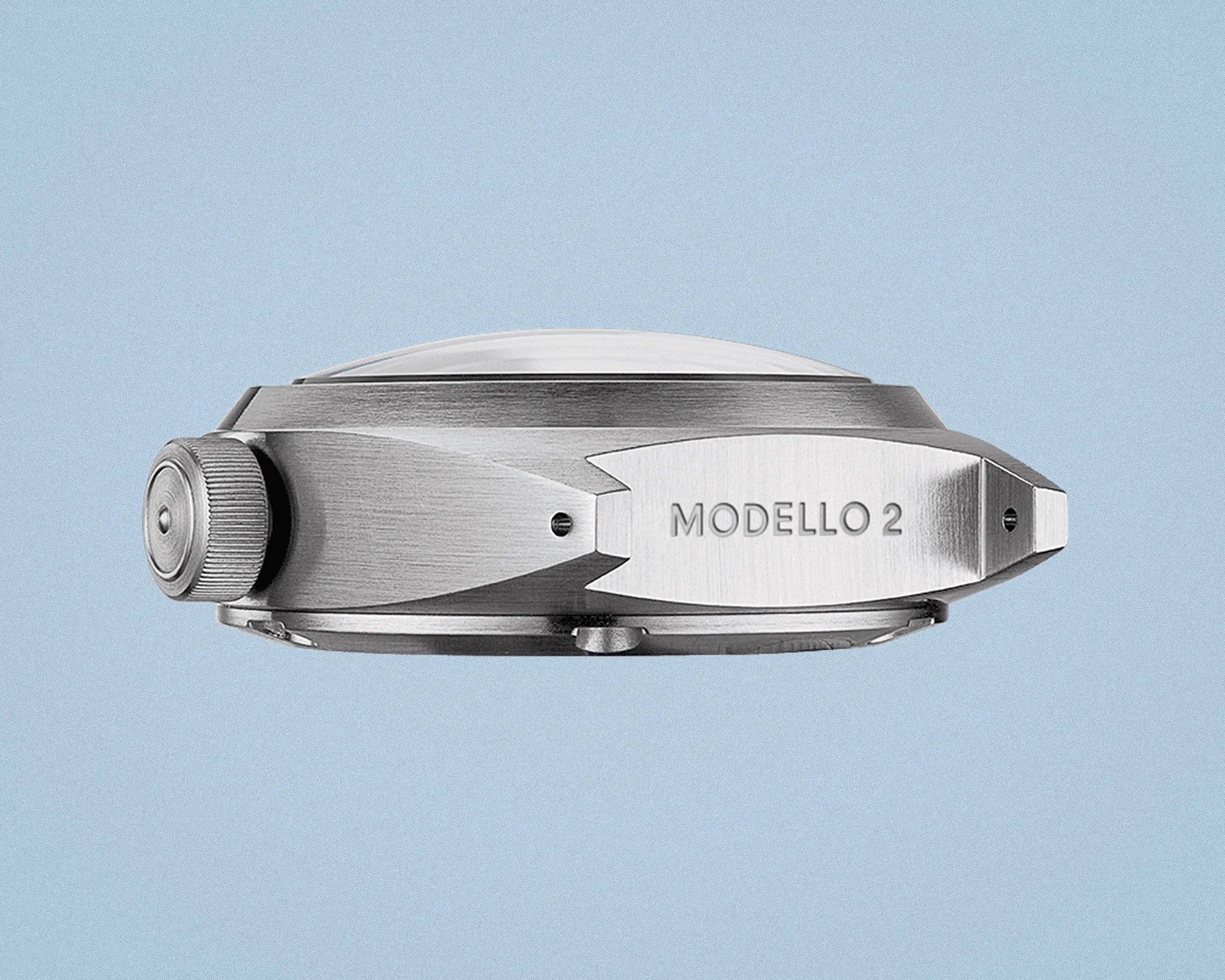 Side view of a silver metal watch case with "MODELLO 2" engraved on the lug against a light blue background.