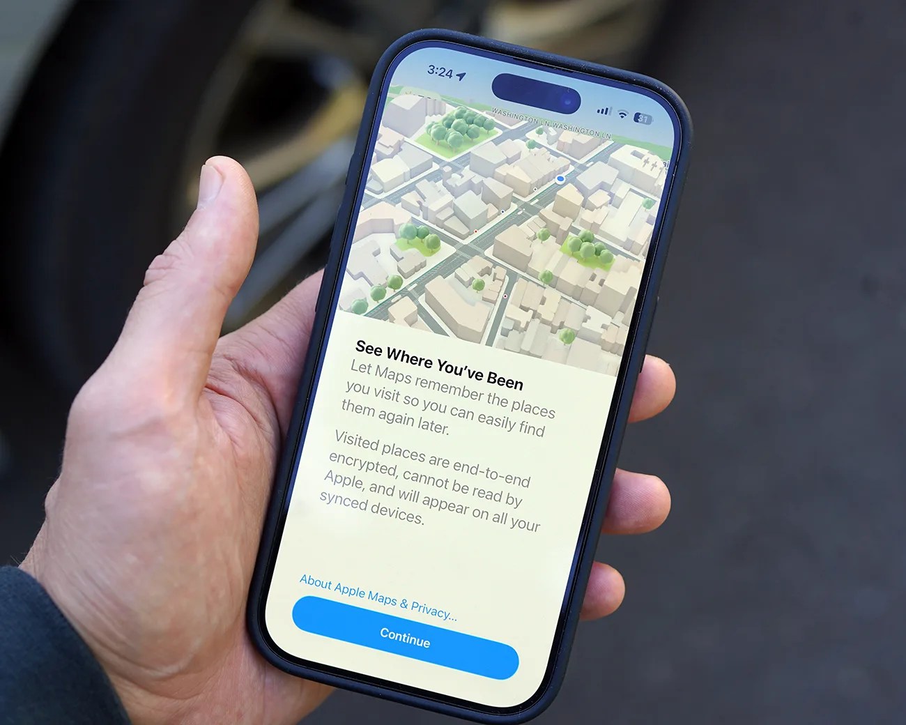 Hand holding a smartphone displaying Apple Maps screen with a "See Where You've Been" privacy message.