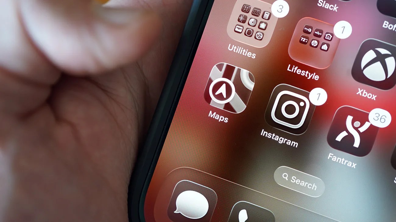 Close-up of a smartphone screen showing app icons for Maps, Instagram, Fantrax, and folders labeled Utilities and Lifestyle.