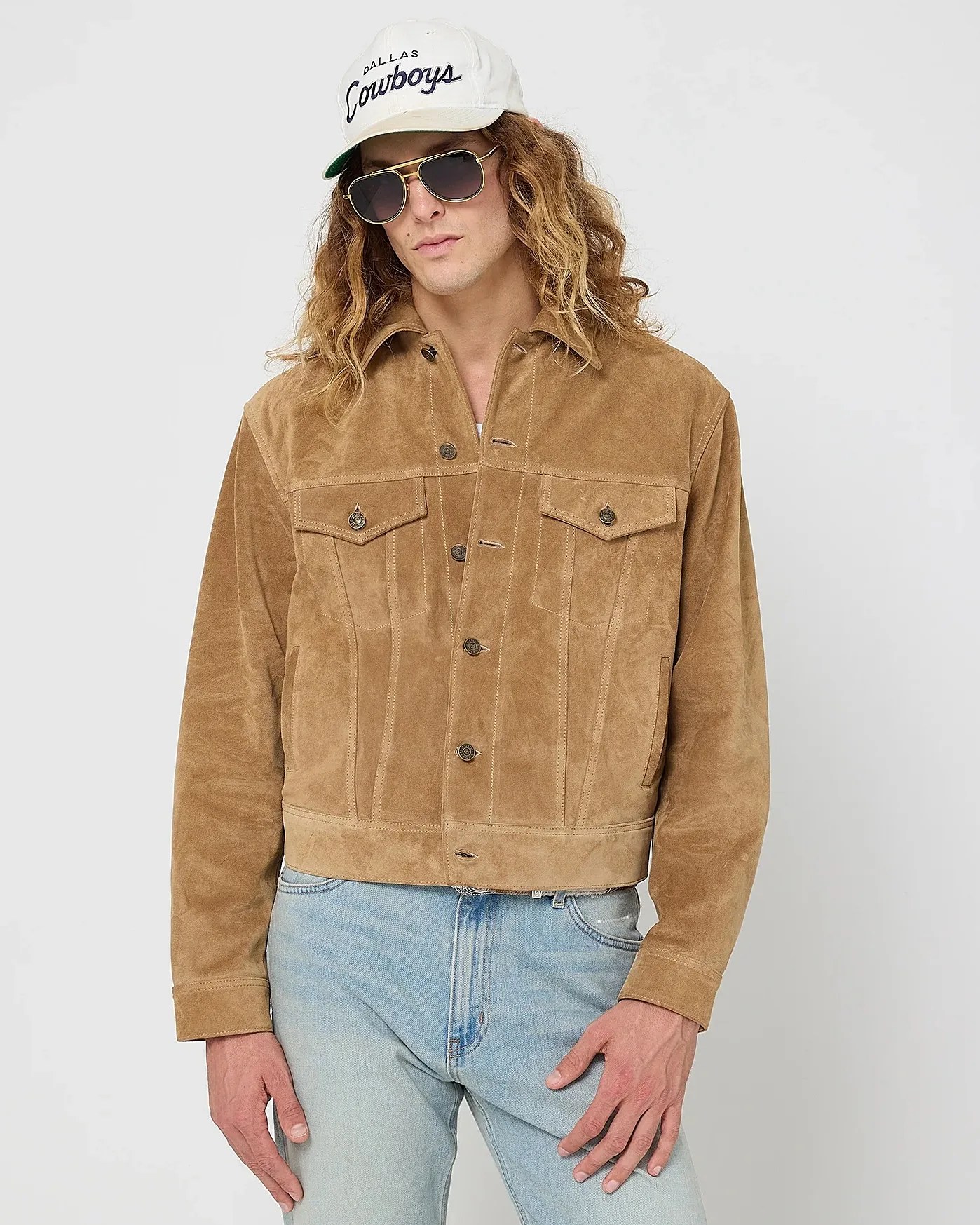 Light brown suede button-up jacket with chest pockets worn with light blue jeans.