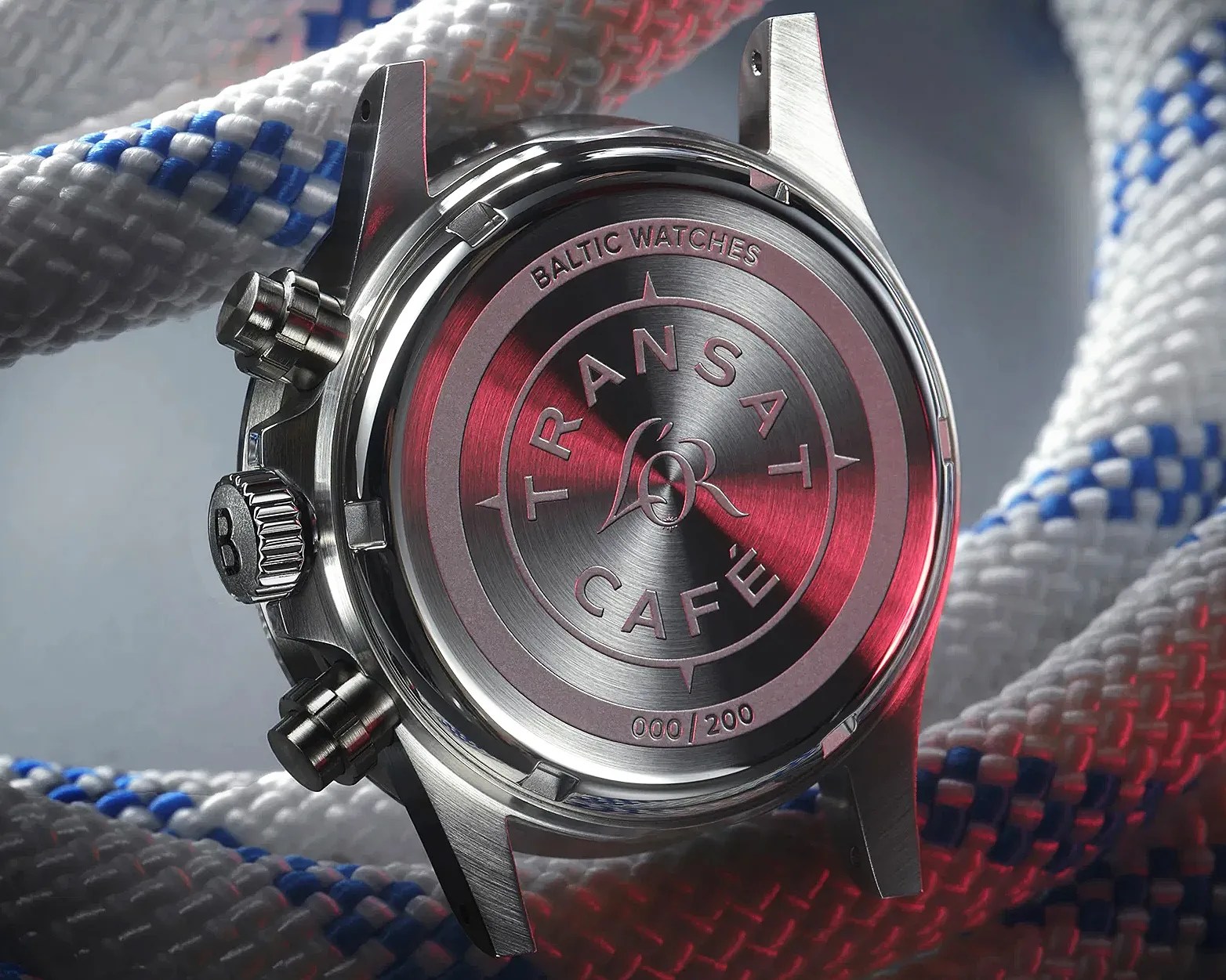 Brushed stainless steel watch case back engraved with "TRANSAT CAFÉ" and "BALTIC WATCHES" surrounded by white and blue rope.