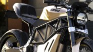 Close-up of a white and black electric motorcycle with a visible "BBM" logo on the fuel tank area.