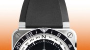 Square stainless steel watch with black rubber strap and black-and-white compass-style dial.