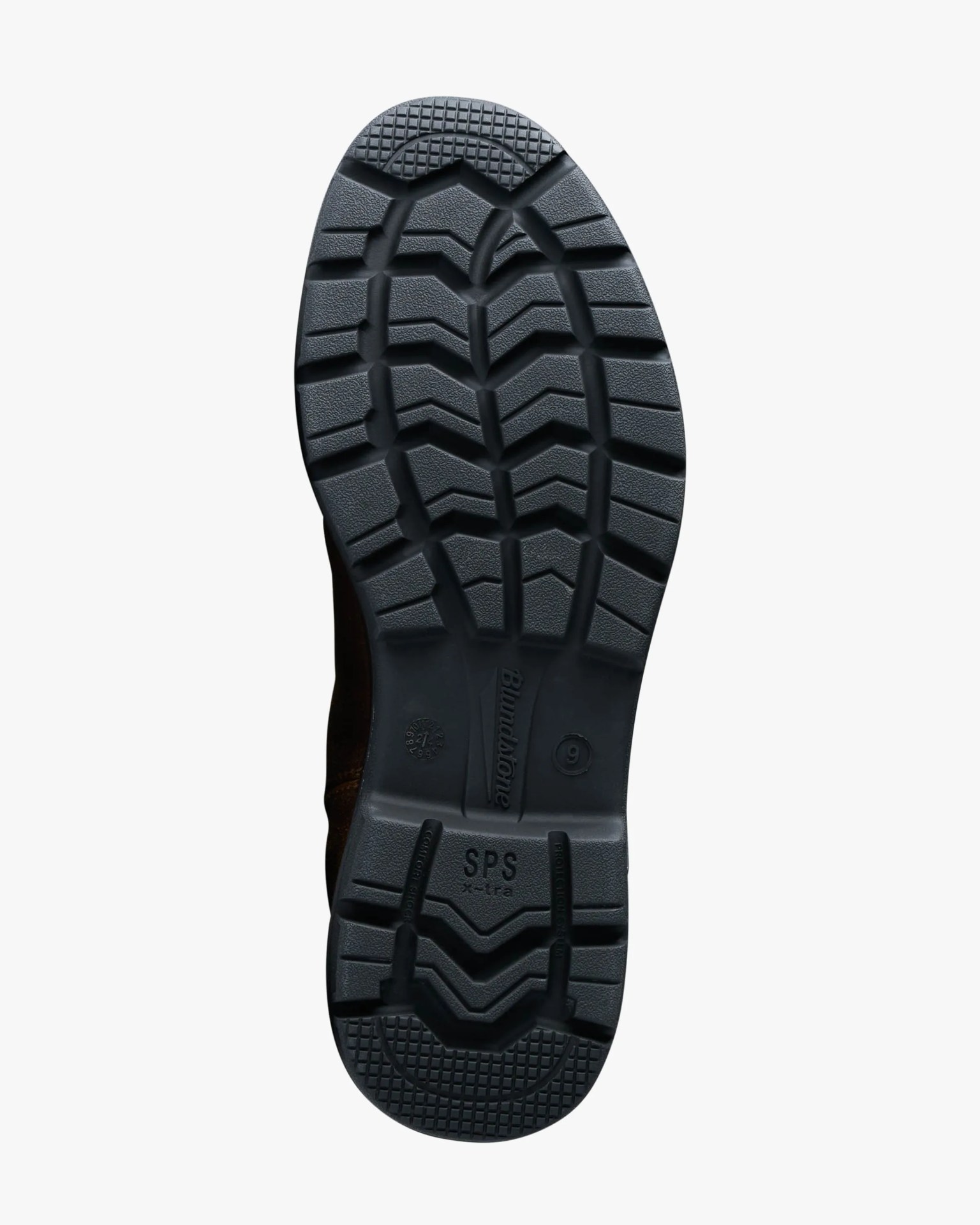 Black rubber boot sole with deep tread pattern and "Blundstone SPS x-tra" branding.