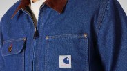 Blue denim jacket with brown corduroy collar and Carhartt logo patch on chest pocket.