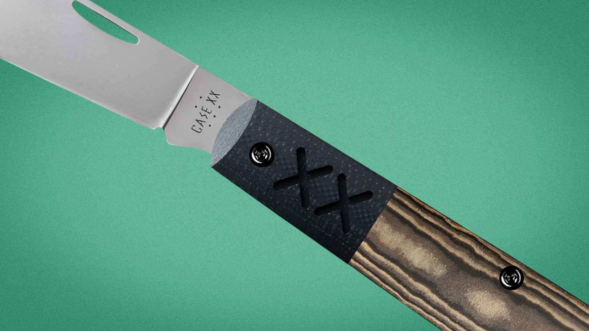 Knife with a stainless steel blade and a handle combining black textured material with wood grain finish.