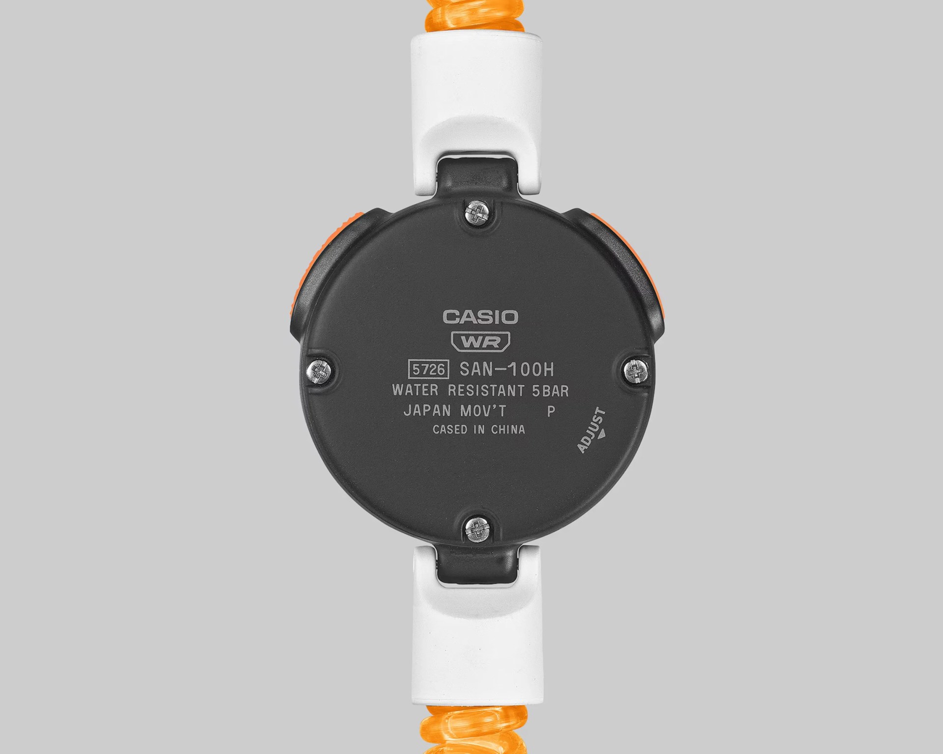 Back of a Casio SAN-100H watch with black case, white and orange strap, and water resistance details.
