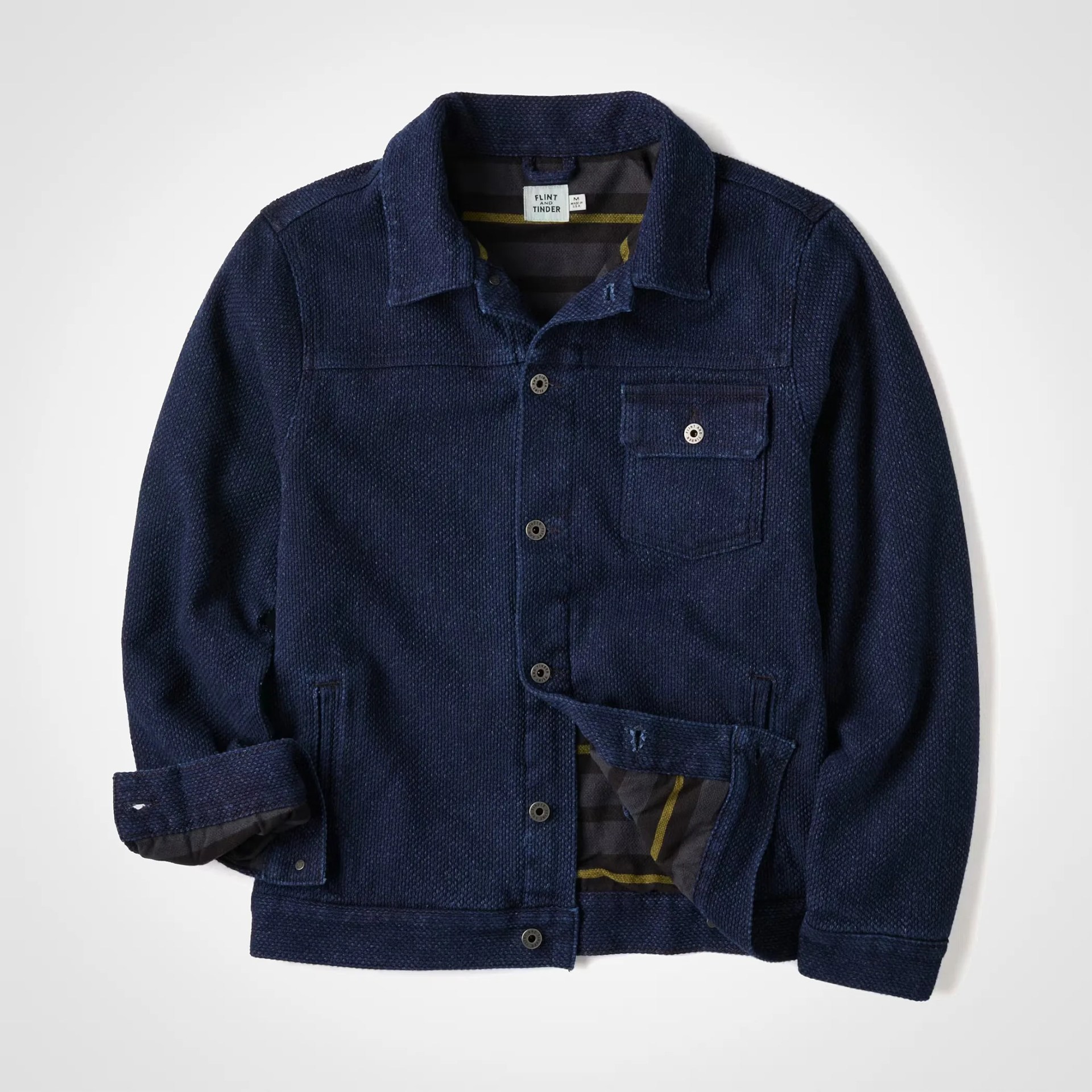 Navy blue textured button-up jacket with a chest pocket and striped inner lining.