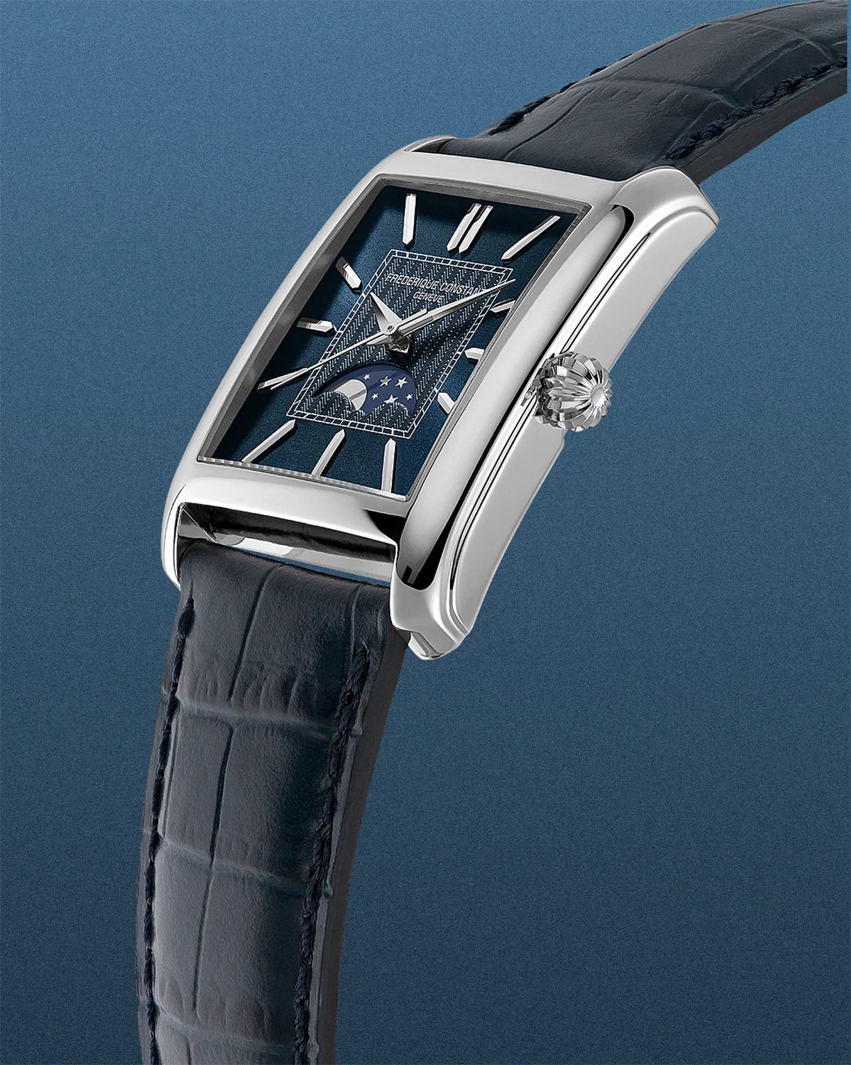 Rectangular silver watch with a blue textured dial, moon phase display, and dark blue leather strap.