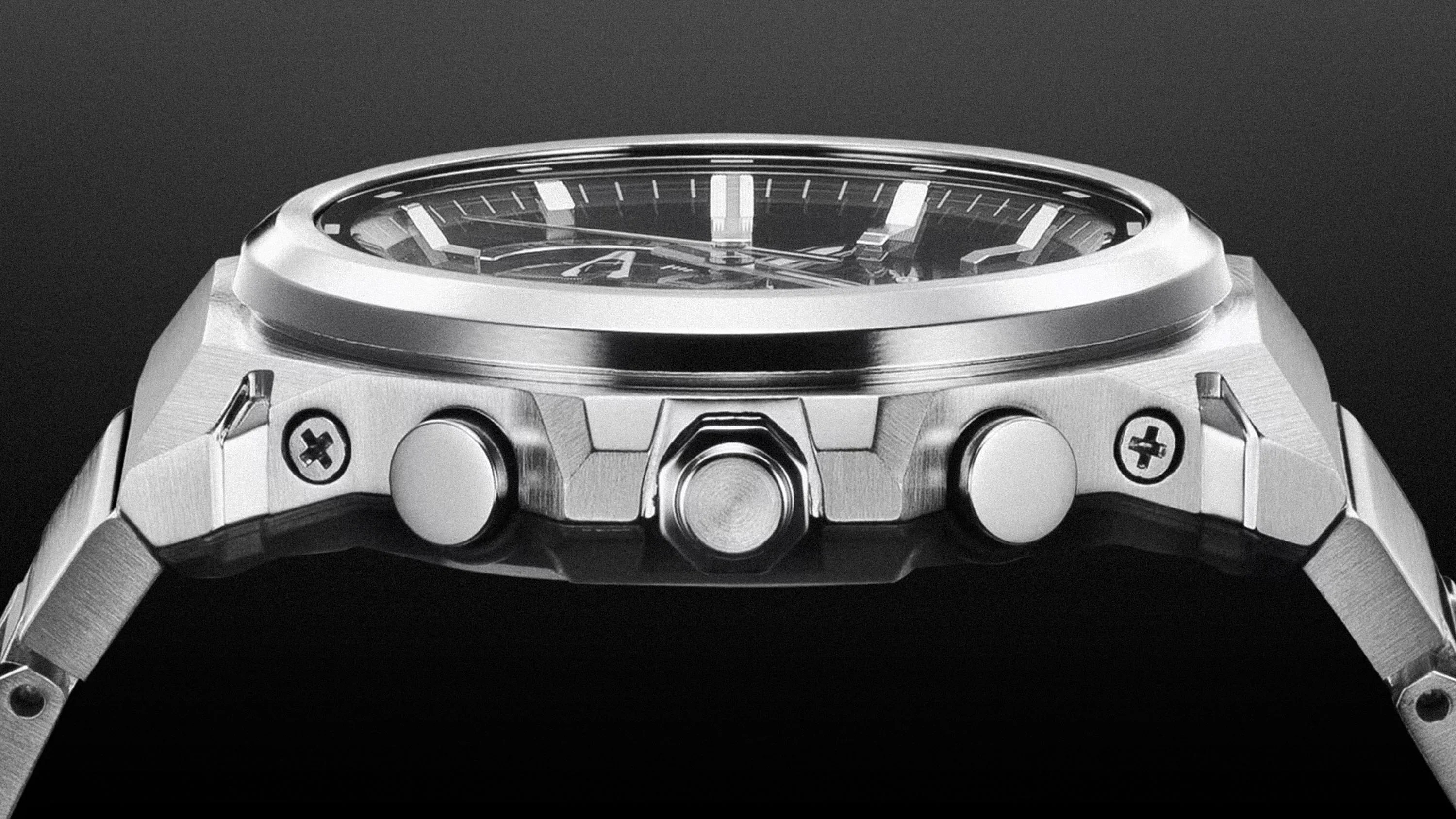 Close-up of a silver metal wristwatch side showing two push buttons, a crown, and screws on a black background.